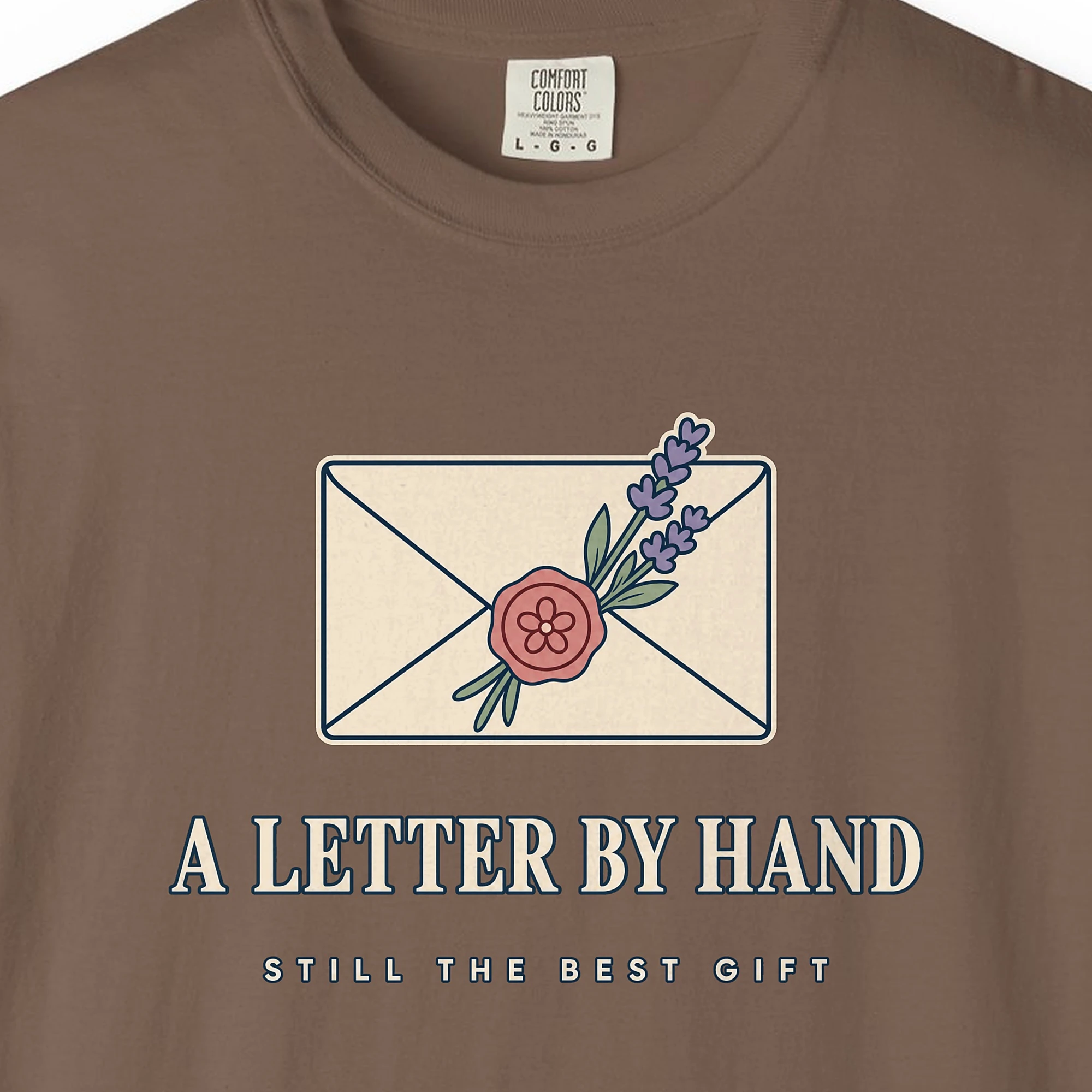 a-letter-by-hand-tee-espresso-chest Close-up of the A Letter by Hand print on a Espresso Comfort Colors 1717 tee