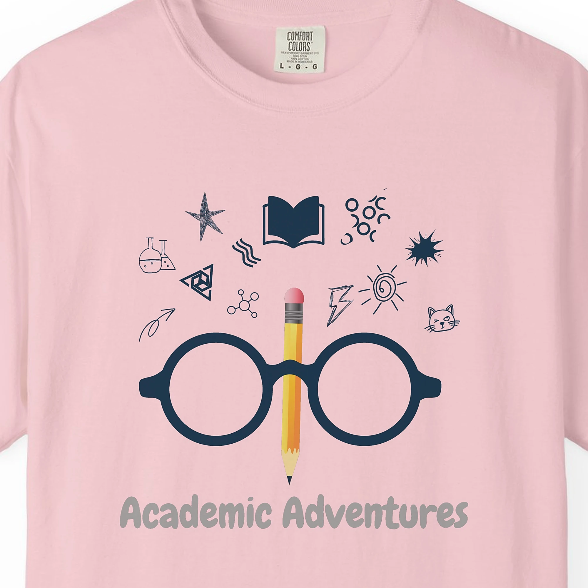 Close-up of the Academic Adventures print on a Blossom Comfort Colors 1717 tee