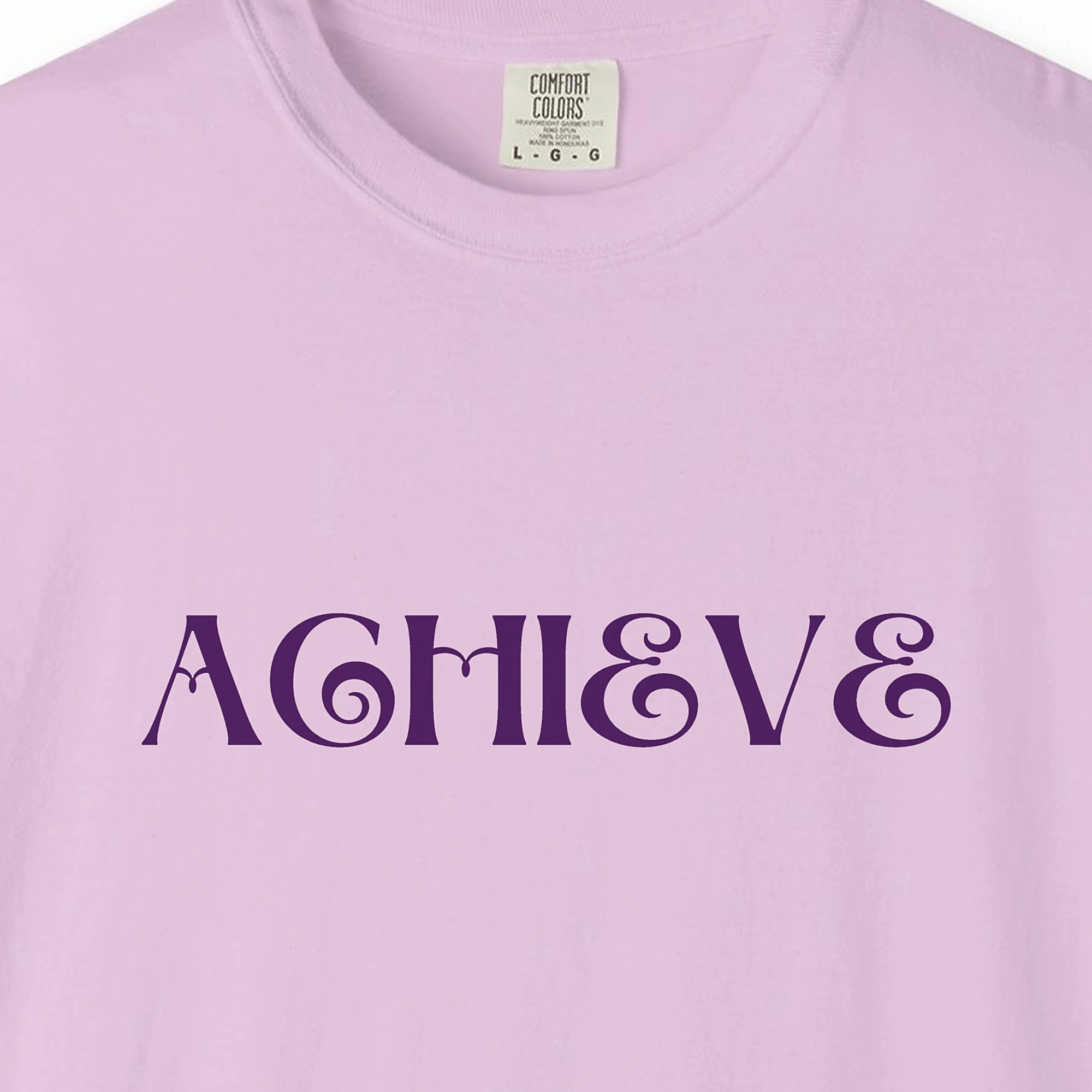 Close-up of the Achieve print on a Orchid Comfort Colors 1717 tee