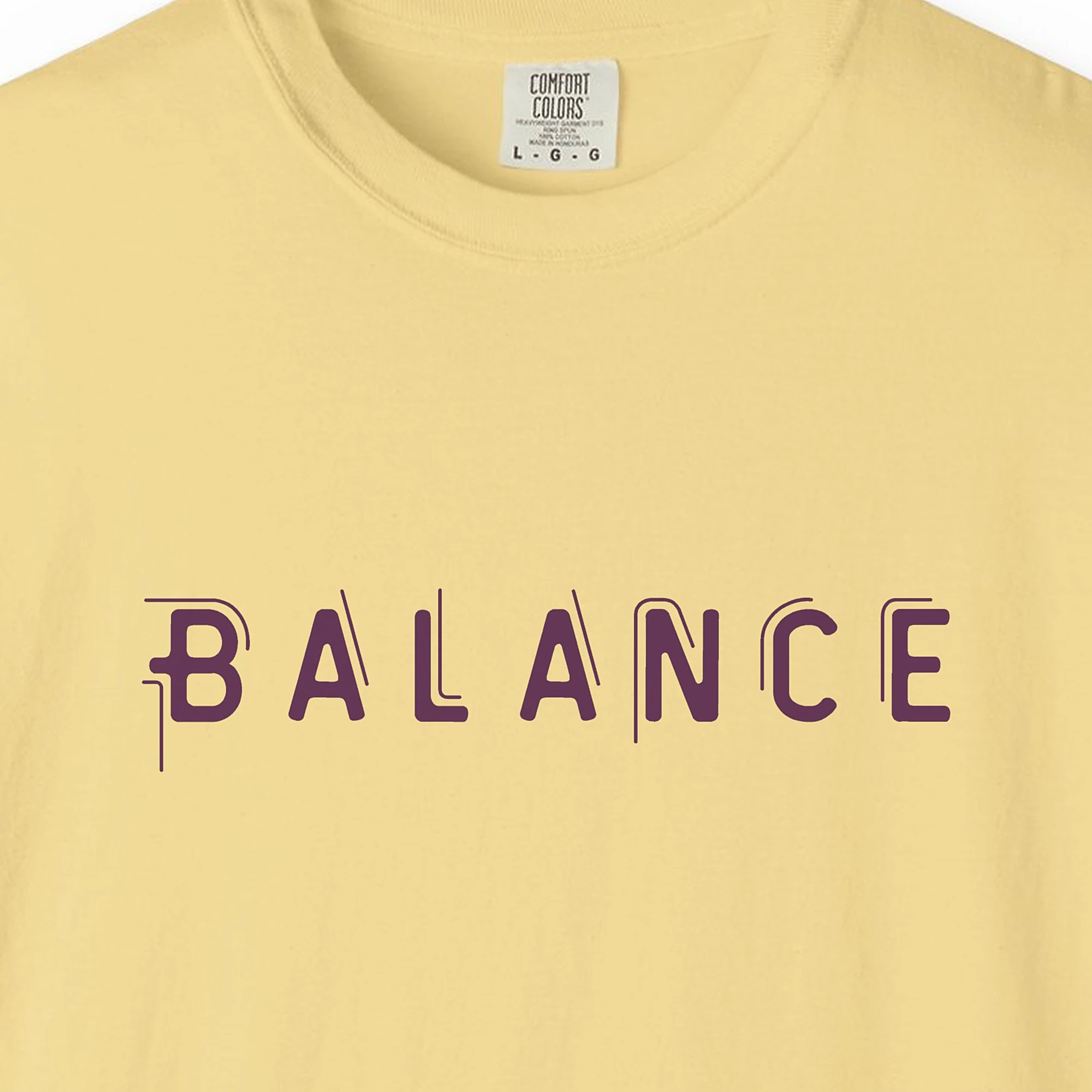 Close-up of the Balance print on a Butter Comfort Colors 1717 tee