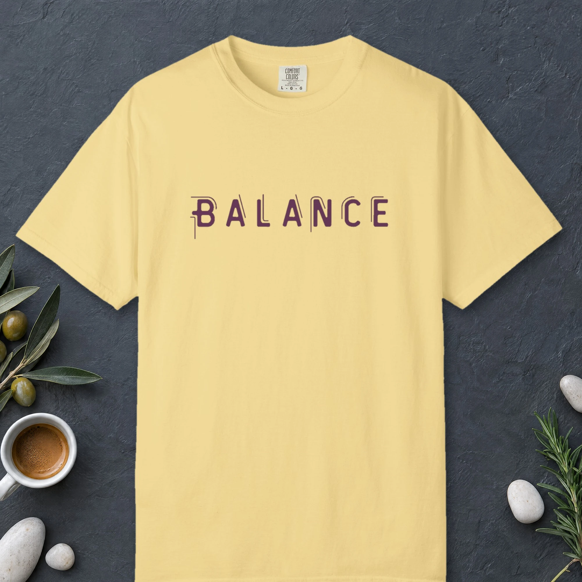 Balance design on a Butter Comfort Colors 1717 tee, laid flat