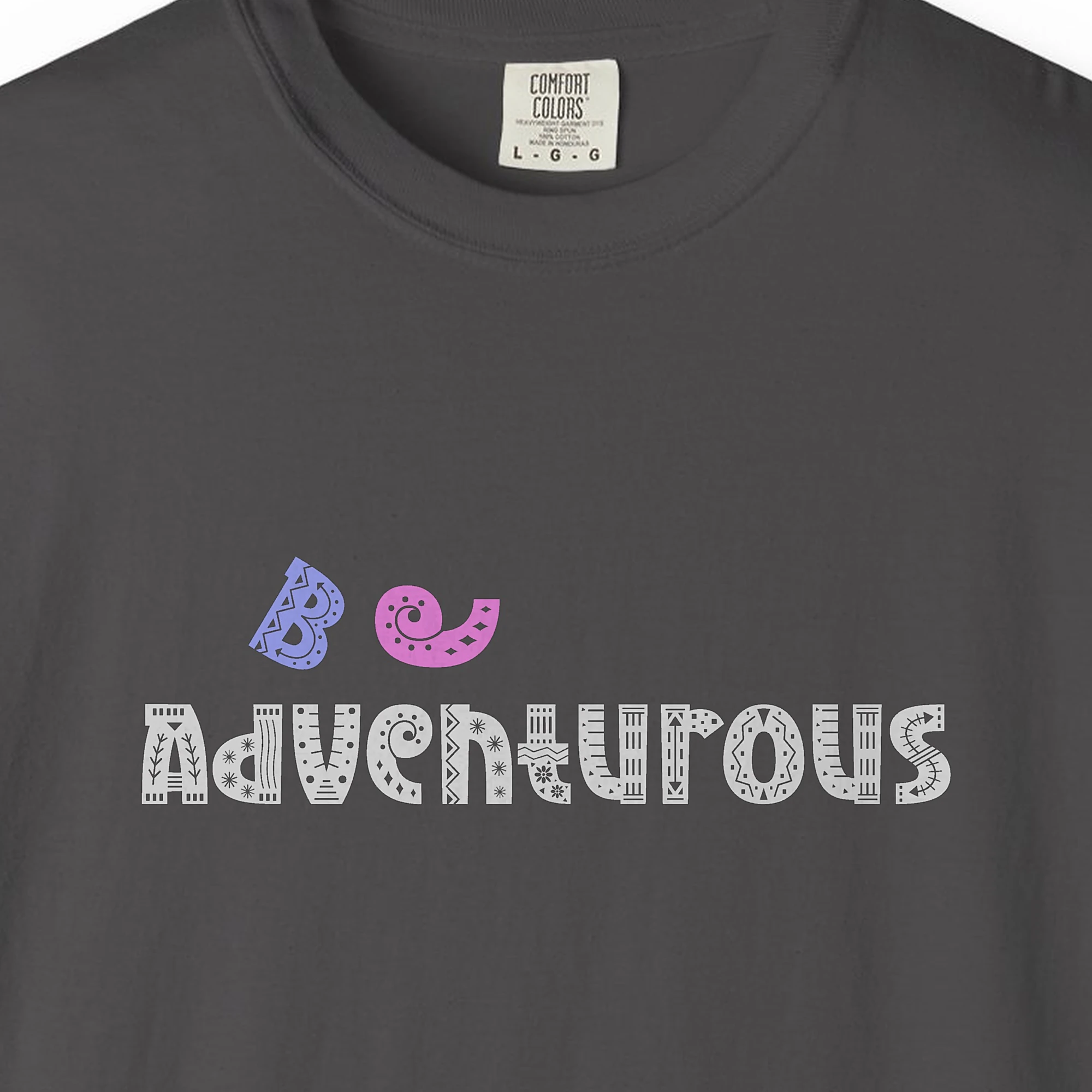 Close-up of the Be Adventurous print on a Graphite Comfort Colors 1717 tee