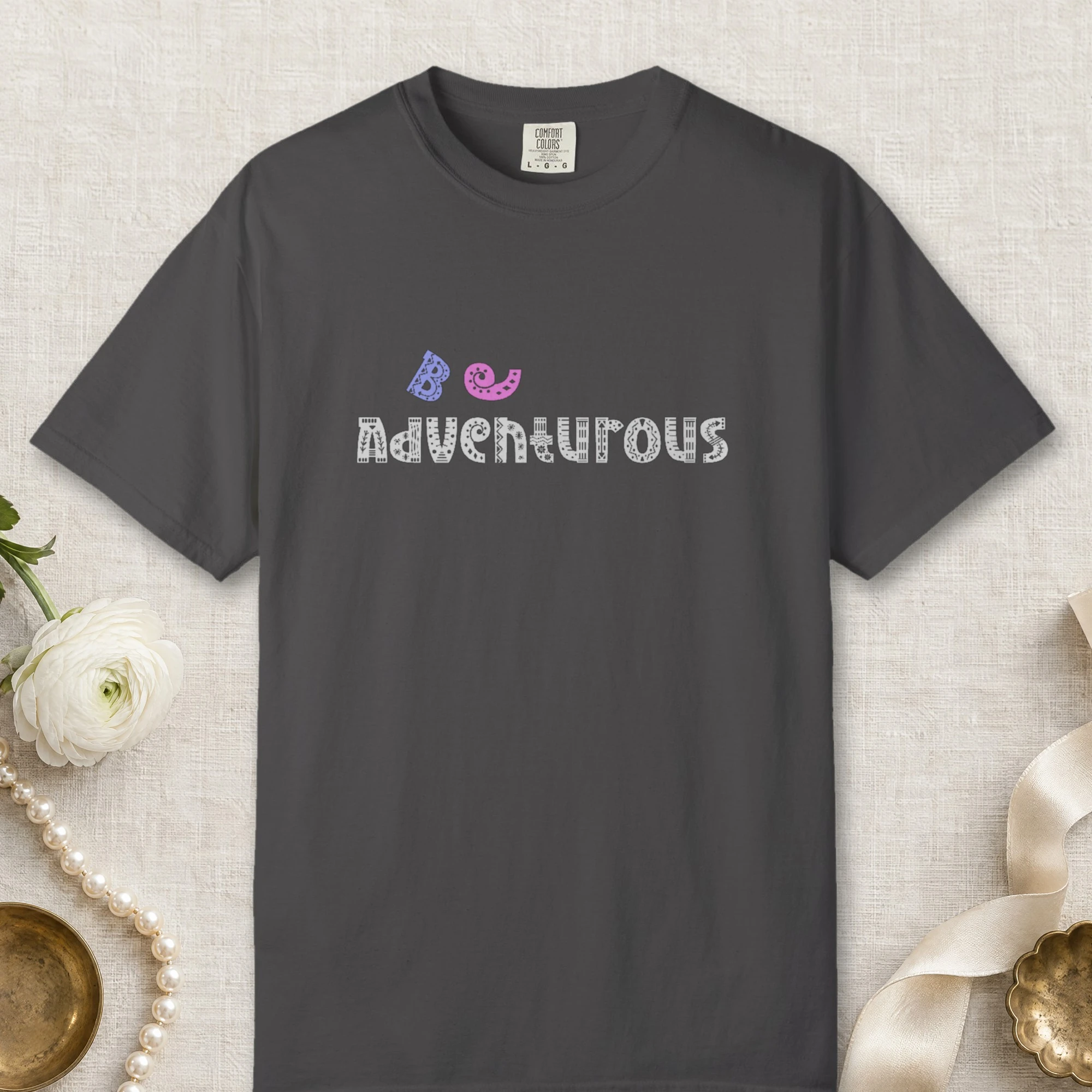 Be Adventurous design on a Graphite Comfort Colors 1717 tee, laid flat