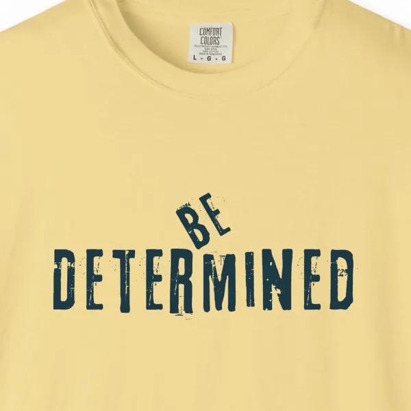 Close-up of the Be Determined print on a Butter Comfort Colors 1717 tee