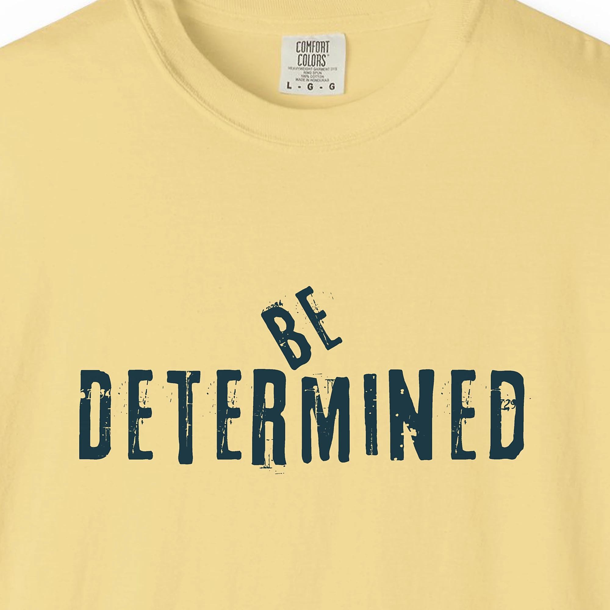 Close-up of the Be Determined print on a Butter Comfort Colors 1717 tee