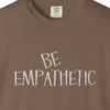 Close-up of the Be Empathetic print on a Espresso Comfort Colors 1717 tee