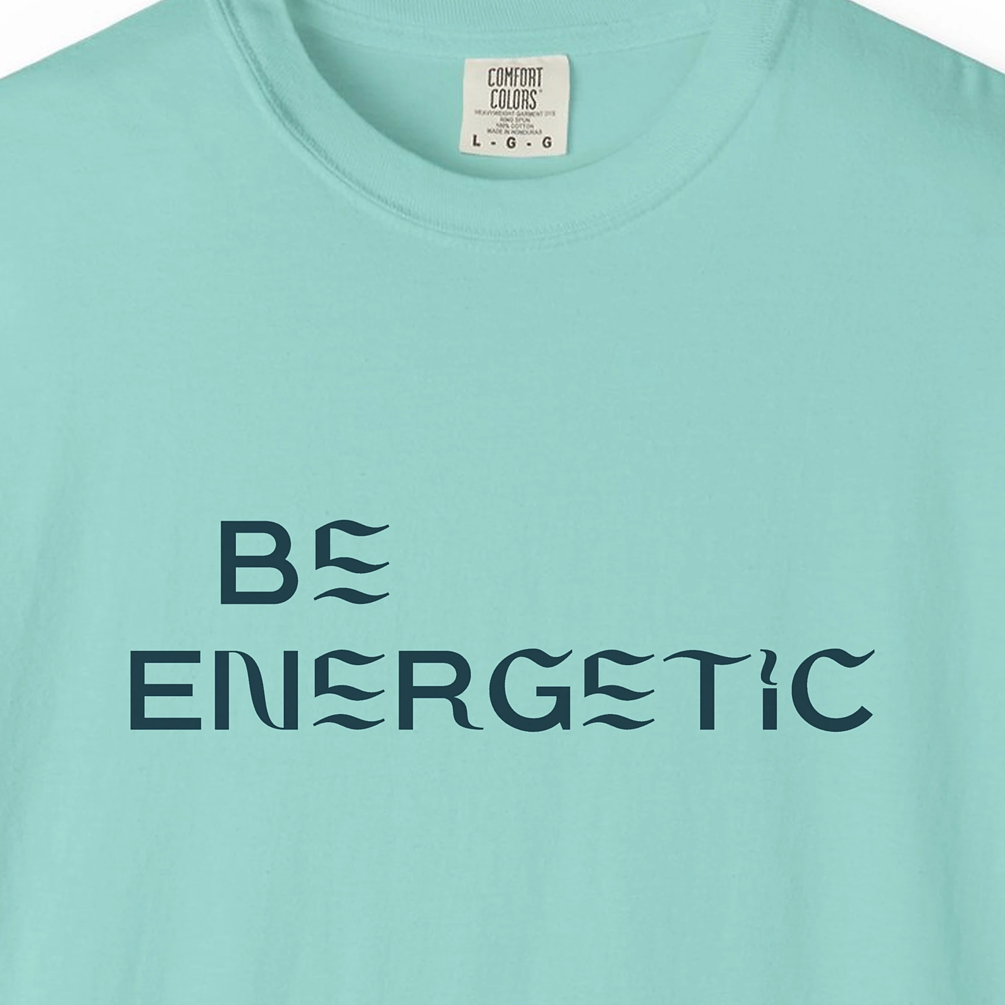 Close-up of the Be Energetic print on a Chalky Mint Comfort Colors 1717 tee