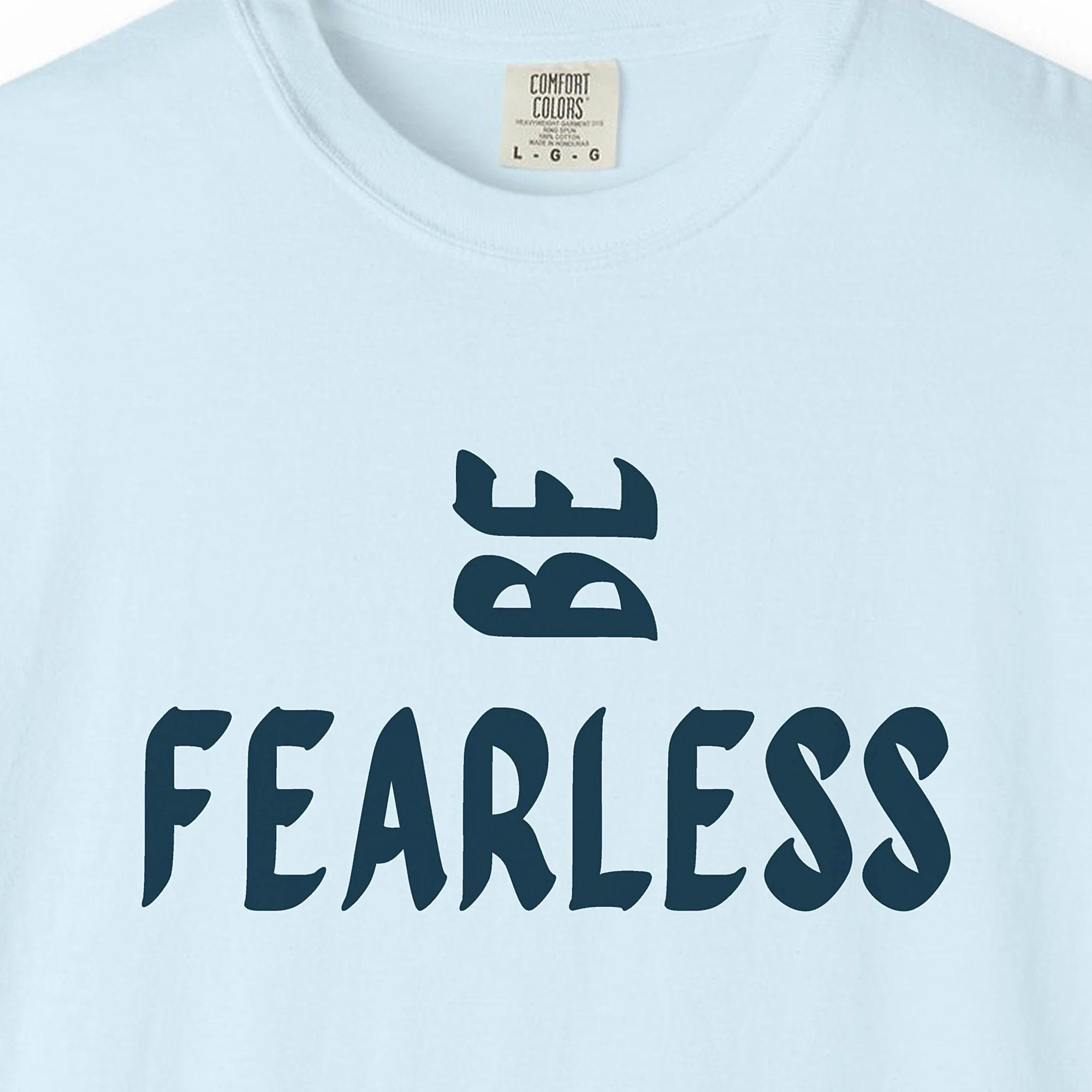 Close-up of the Be Fearless print on a Chambray Comfort Colors 1717 tee
