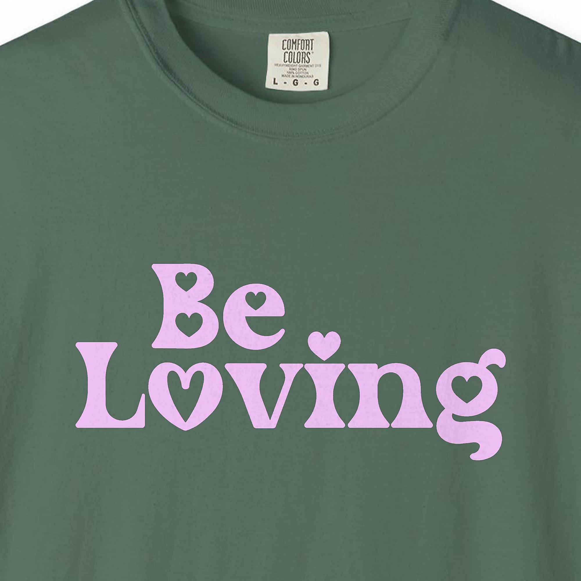 Close-up of the Be Loving print on a Blue Spruce Comfort Colors 1717 tee
