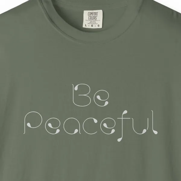 Close-up of the Be Peaceful print on a Moss Comfort Colors 1717 tee