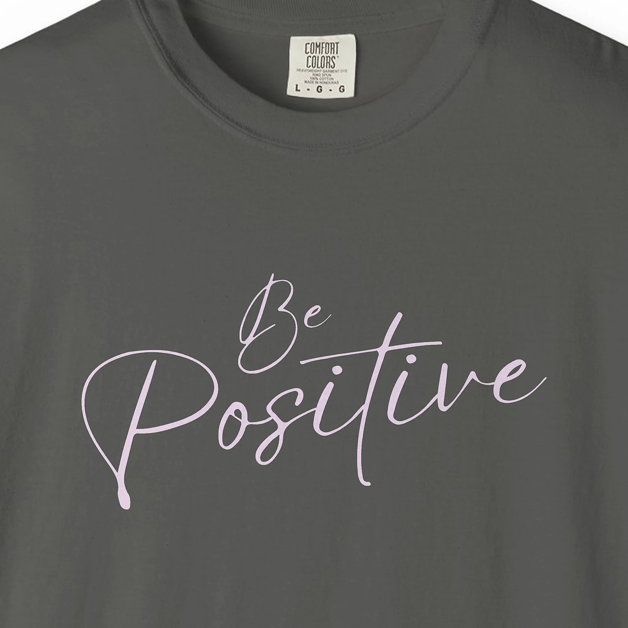 Close-up of the Be Positive print on a Pepper Comfort Colors 1717 tee