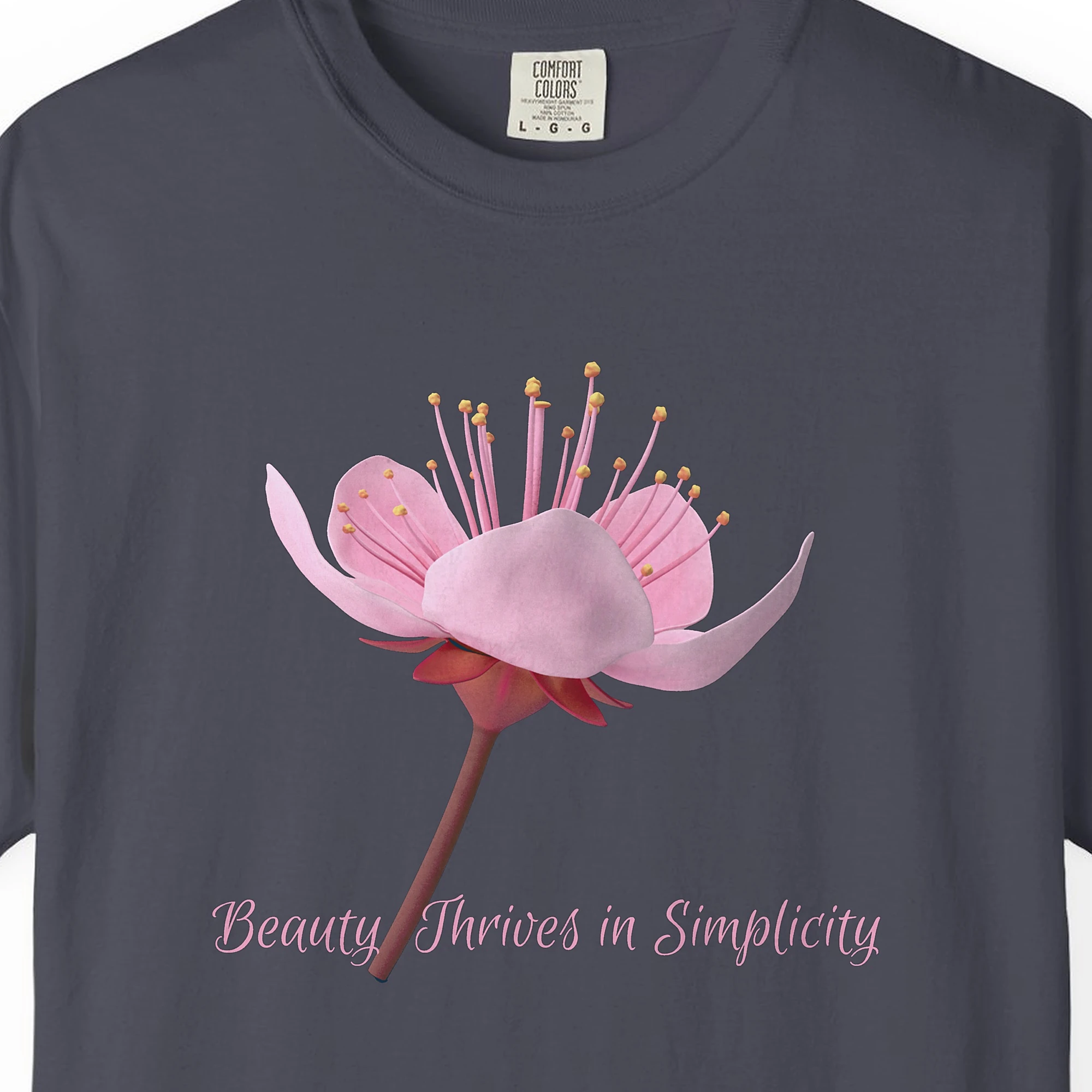Close-up of the Beauty Thrives in Simplicity print on a Navy Comfort Colors 1717 tee