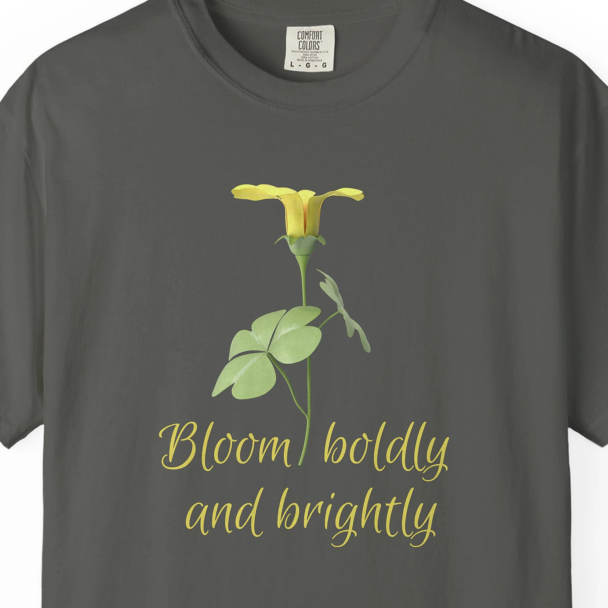 Close-up of the Bloom Boldly print on a Pepper Comfort Colors 1717 tee