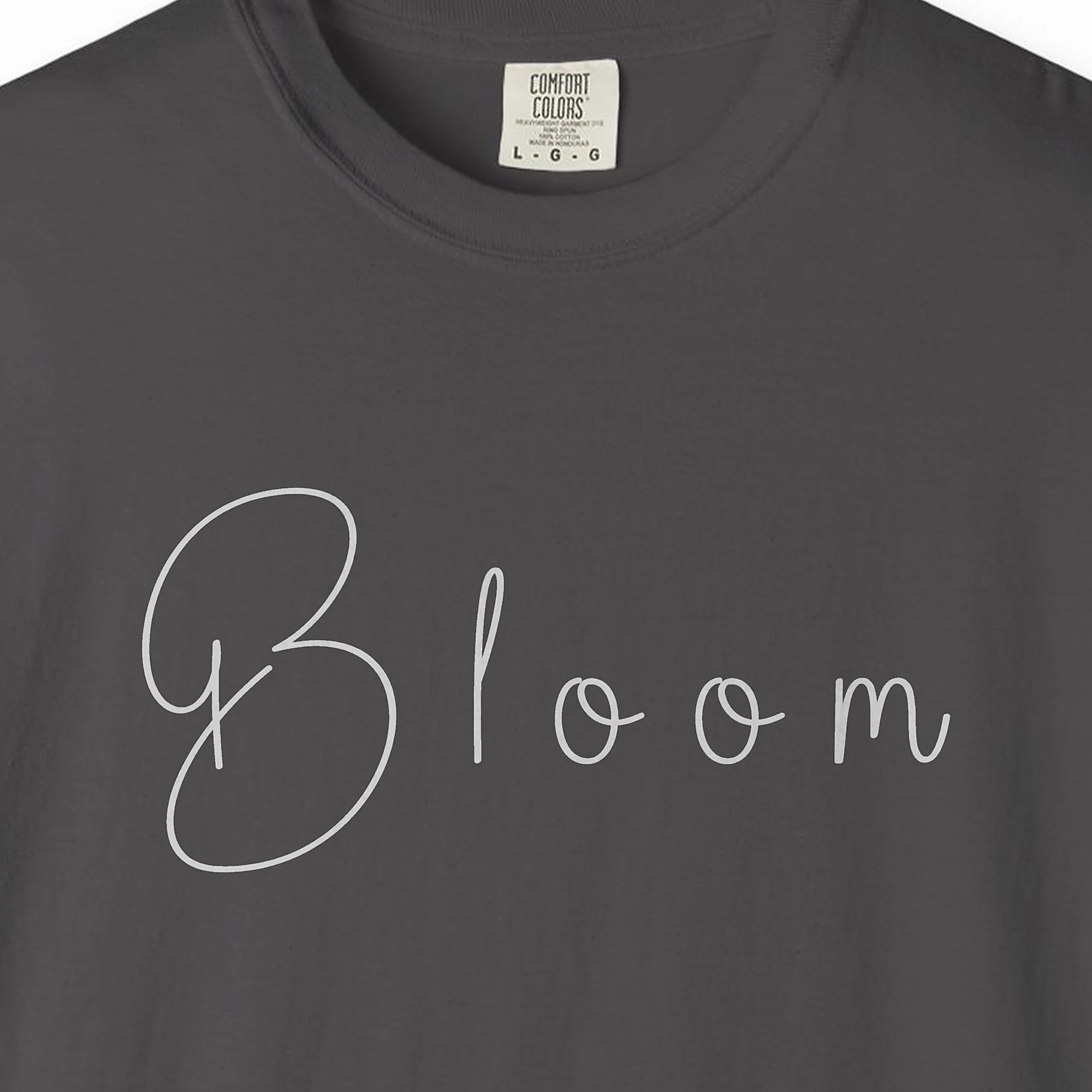 Close-up of the Bloom in Soft Handwriting print on a Graphite Comfort Colors 1717 tee