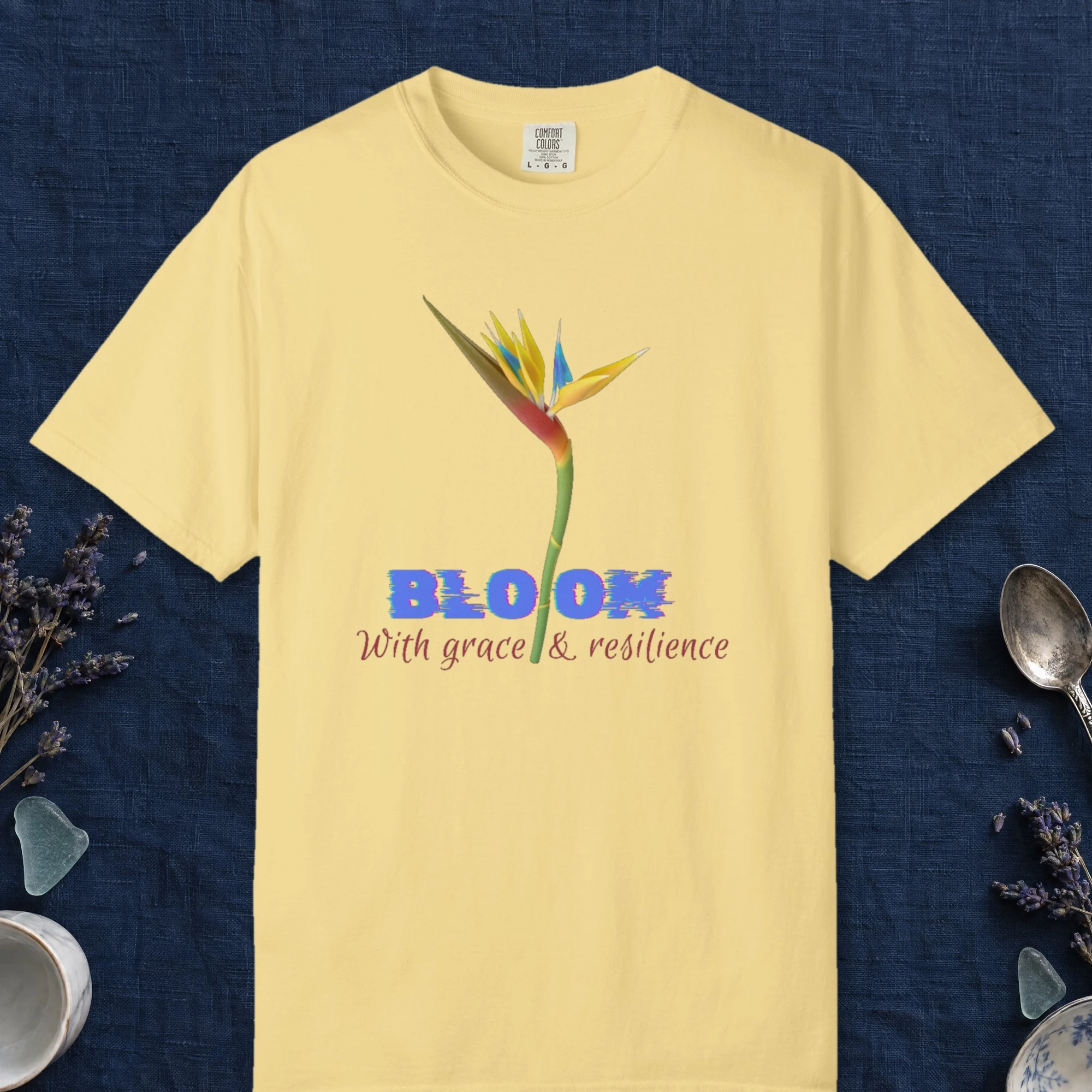 Bloom with Grace design on a Butter Comfort Colors 1717 tee, laid flat