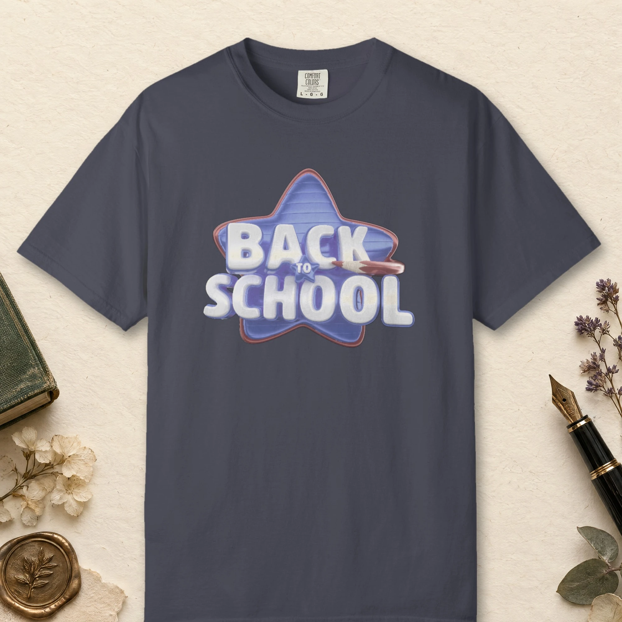 Blue Star School design on a Navy Comfort Colors 1717 tee, laid flat