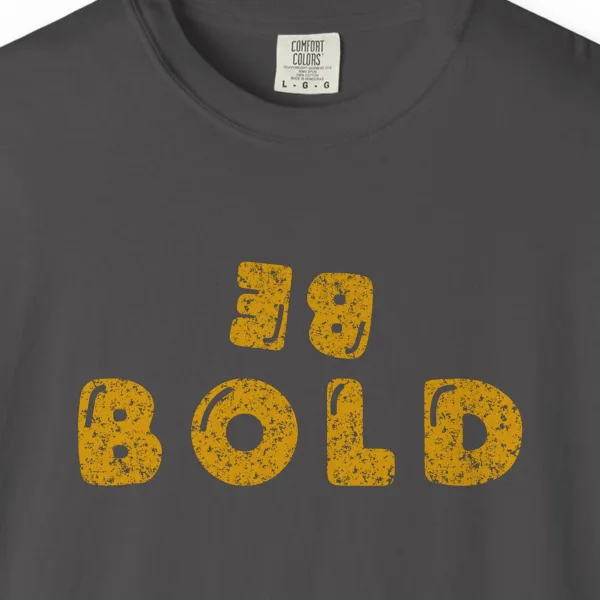 Close-up of the Bold at Heart print on a Graphite Comfort Colors 1717 tee