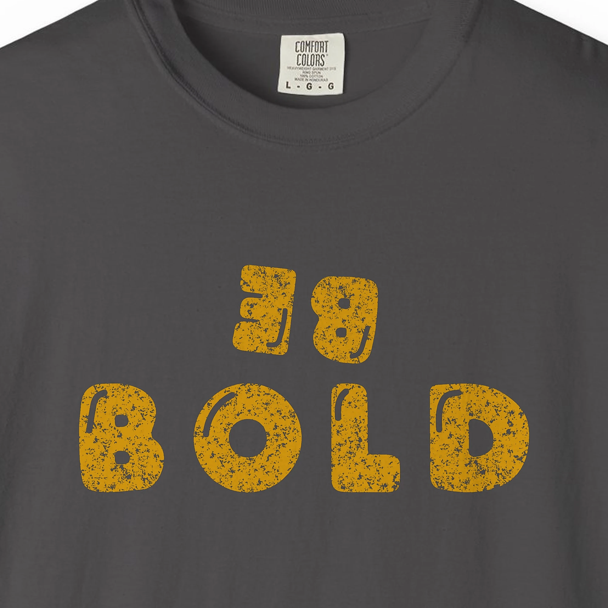 Close-up of the Bold at Heart print on a Graphite Comfort Colors 1717 tee