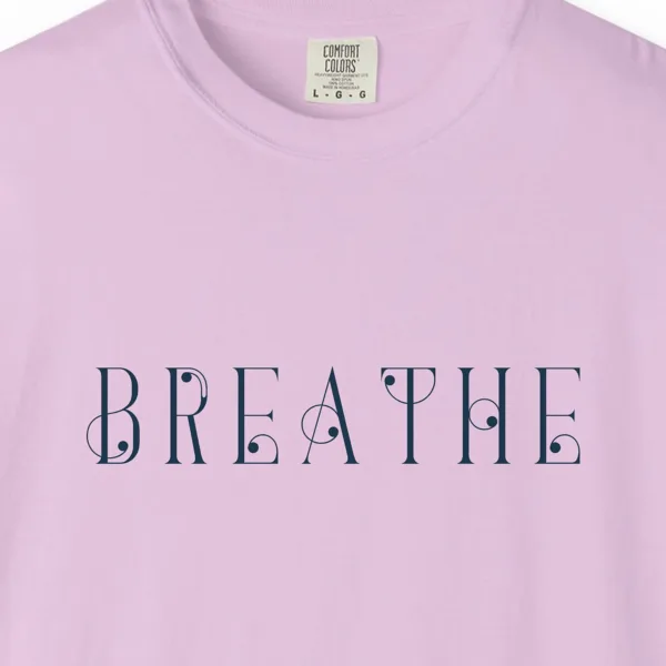 Close-up of the Breathe Art Nouveau print on a Orchid Comfort Colors 1717 tee