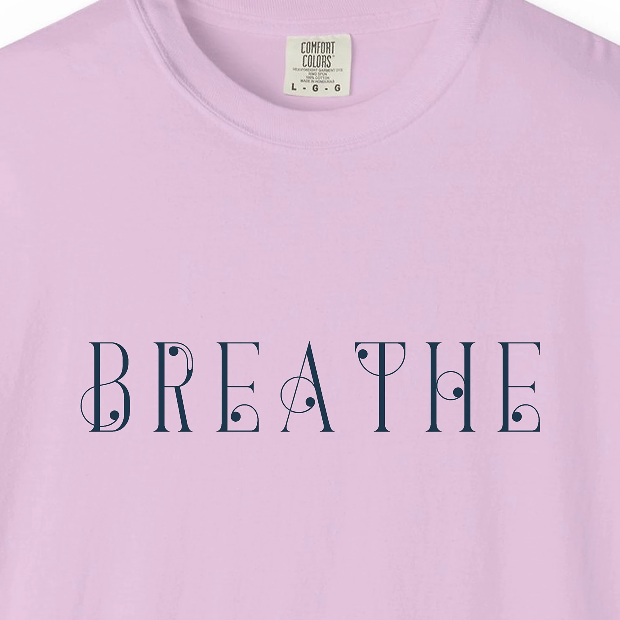 Close-up of the Breathe Art Nouveau print on a Orchid Comfort Colors 1717 tee