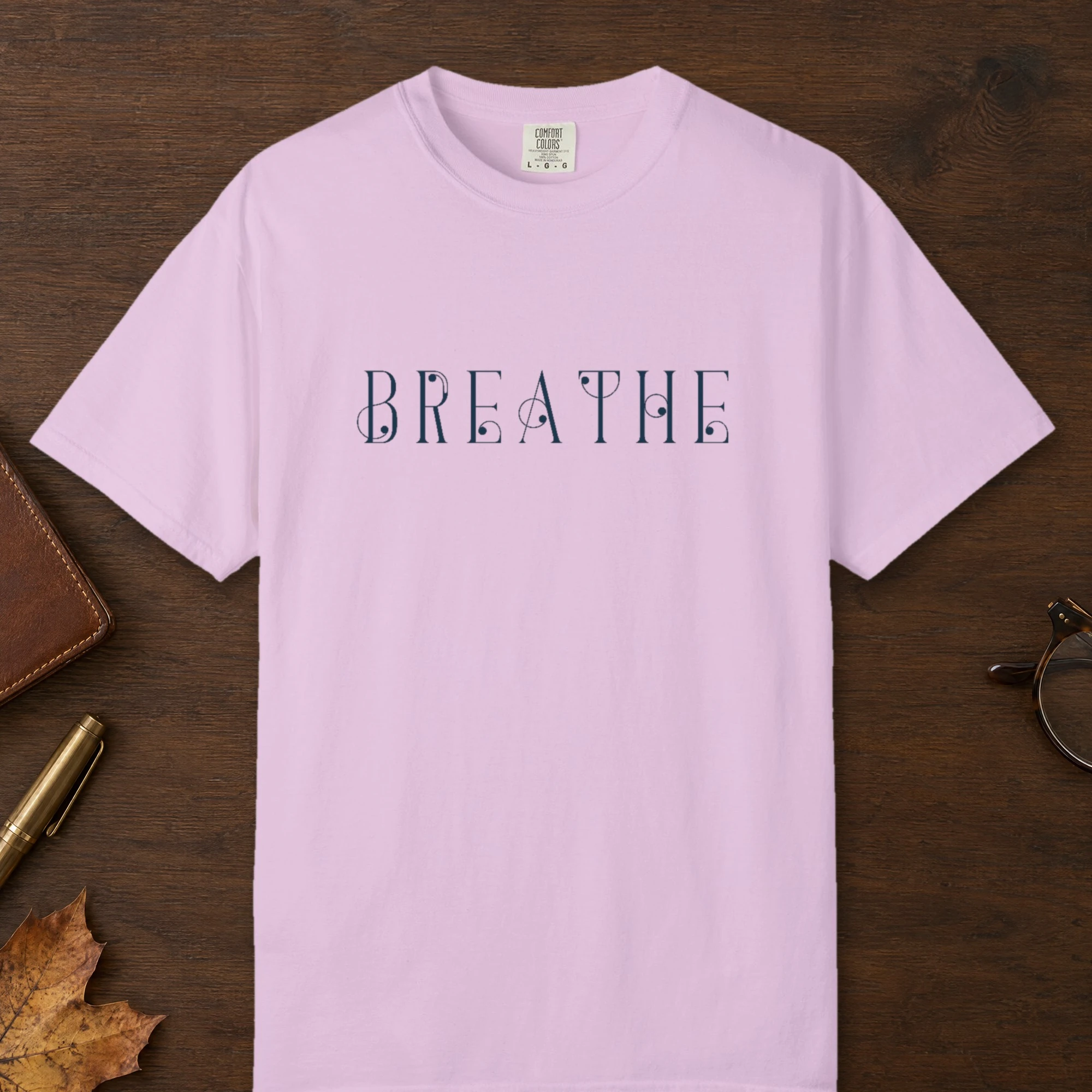 Breathe Art Nouveau design on a Orchid Comfort Colors 1717 tee, laid flat