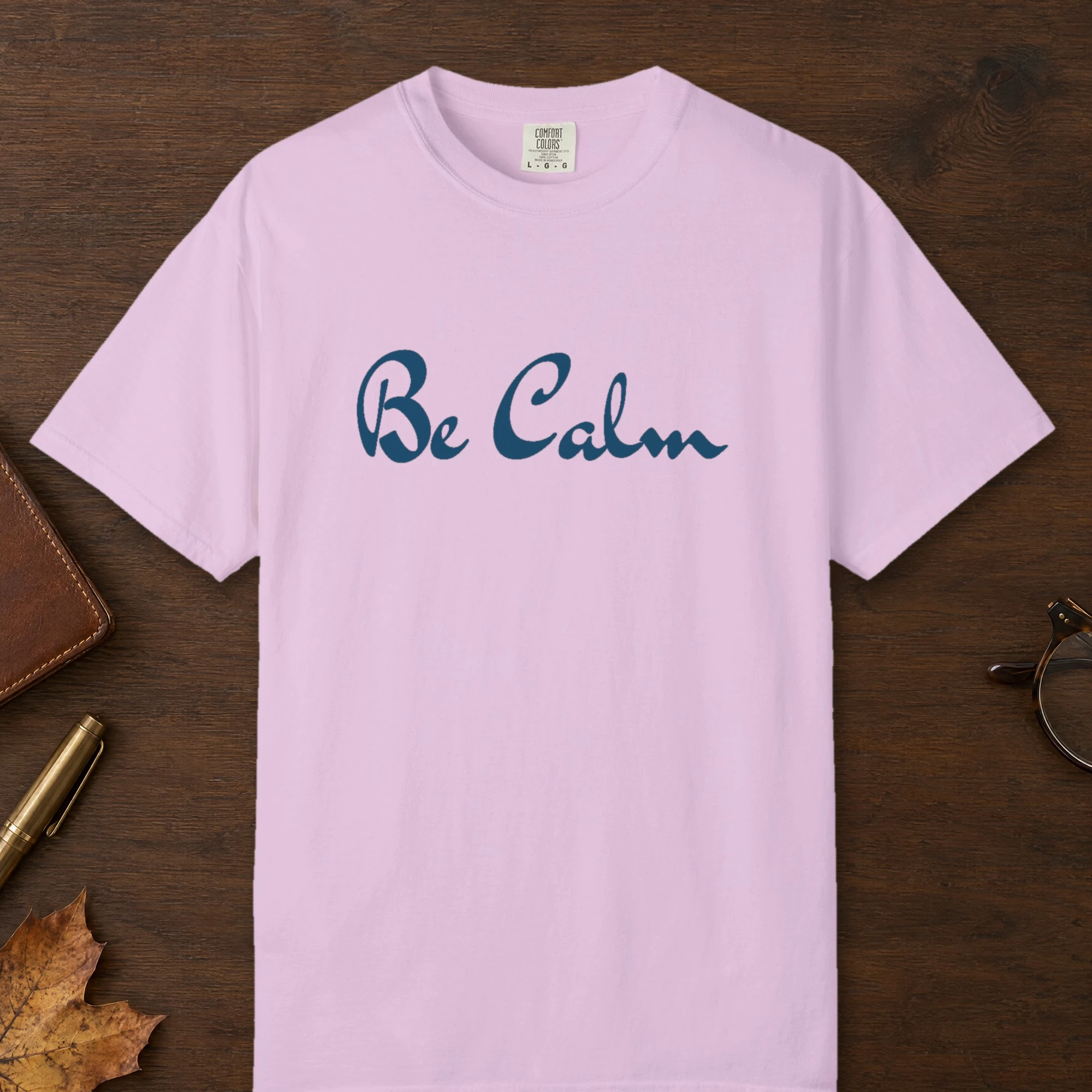 Calm Within design on a Orchid Comfort Colors 1717 tee, laid flat