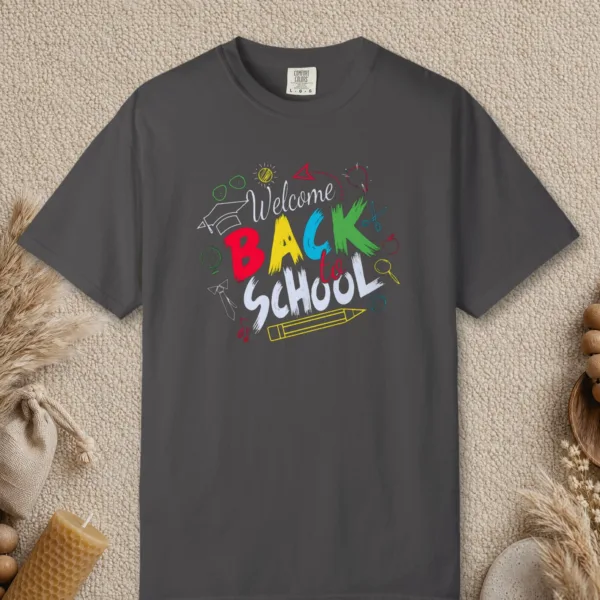Chalk Doodle Welcome design on a Graphite Comfort Colors 1717 tee, laid flat