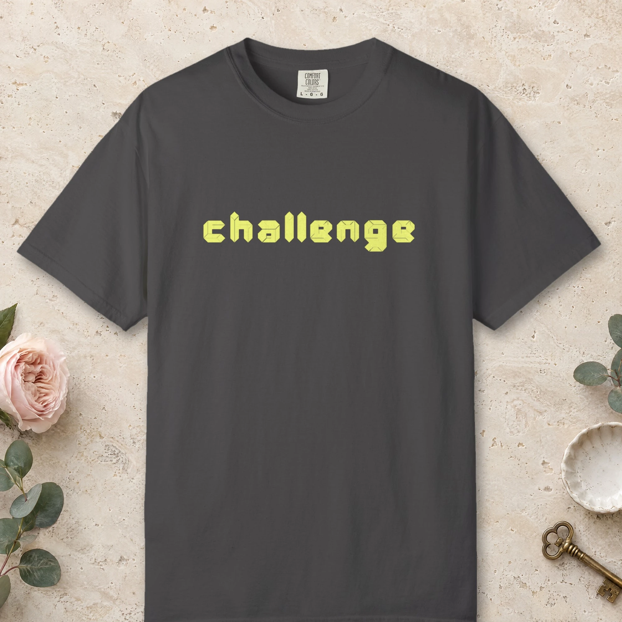 Challenge design on a Graphite Comfort Colors 1717 tee, laid flat