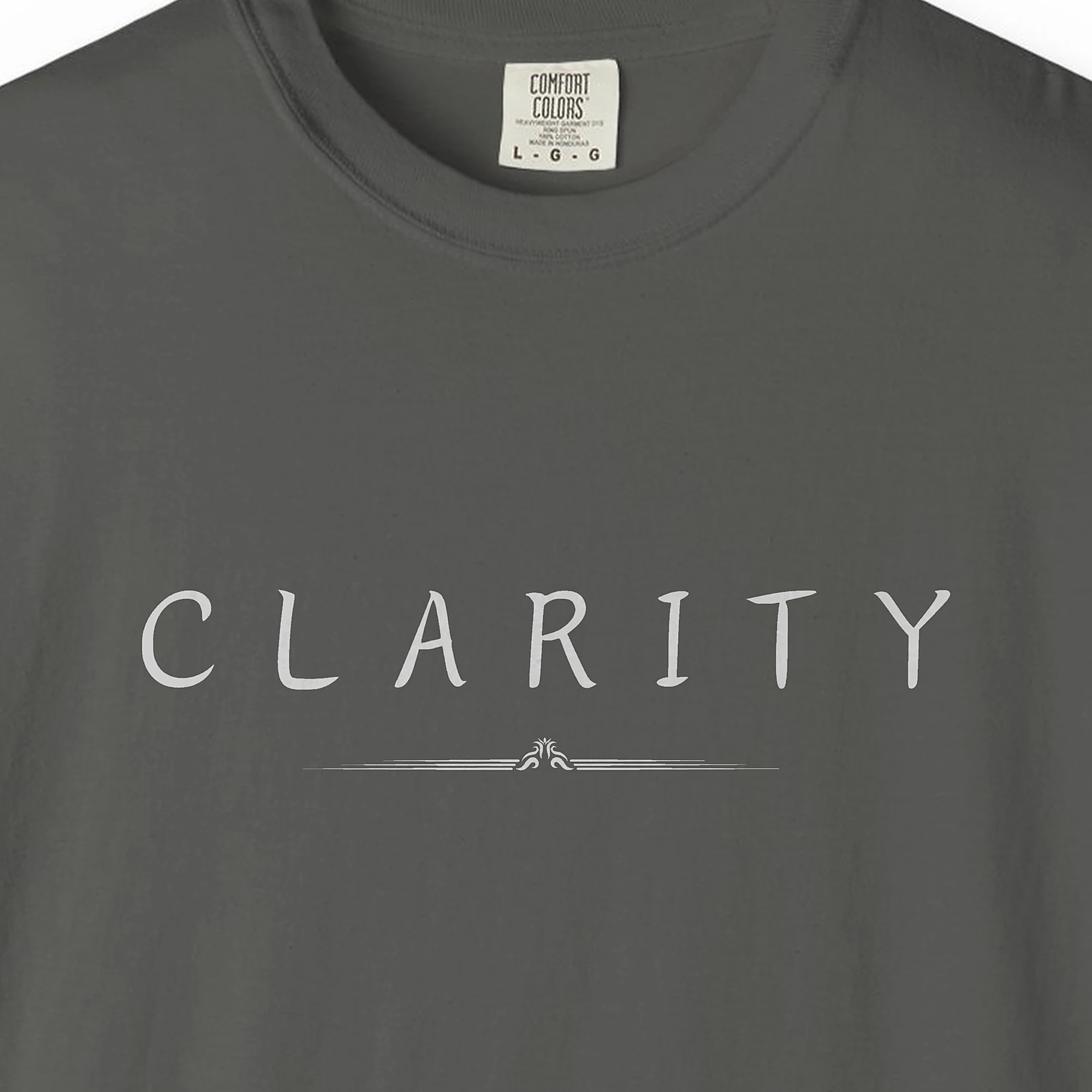 Close-up of the Clarity Crest print on a Pepper Comfort Colors 1717 tee