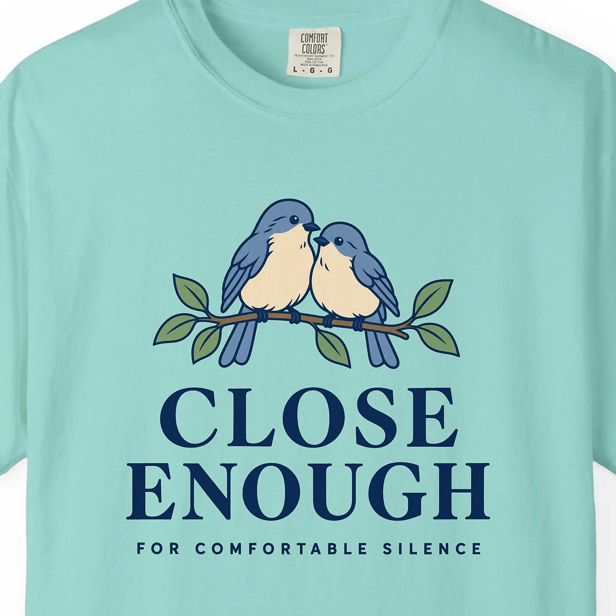 Close-up of the Close Enough print on a Chalky Mint Comfort Colors 1717 tee