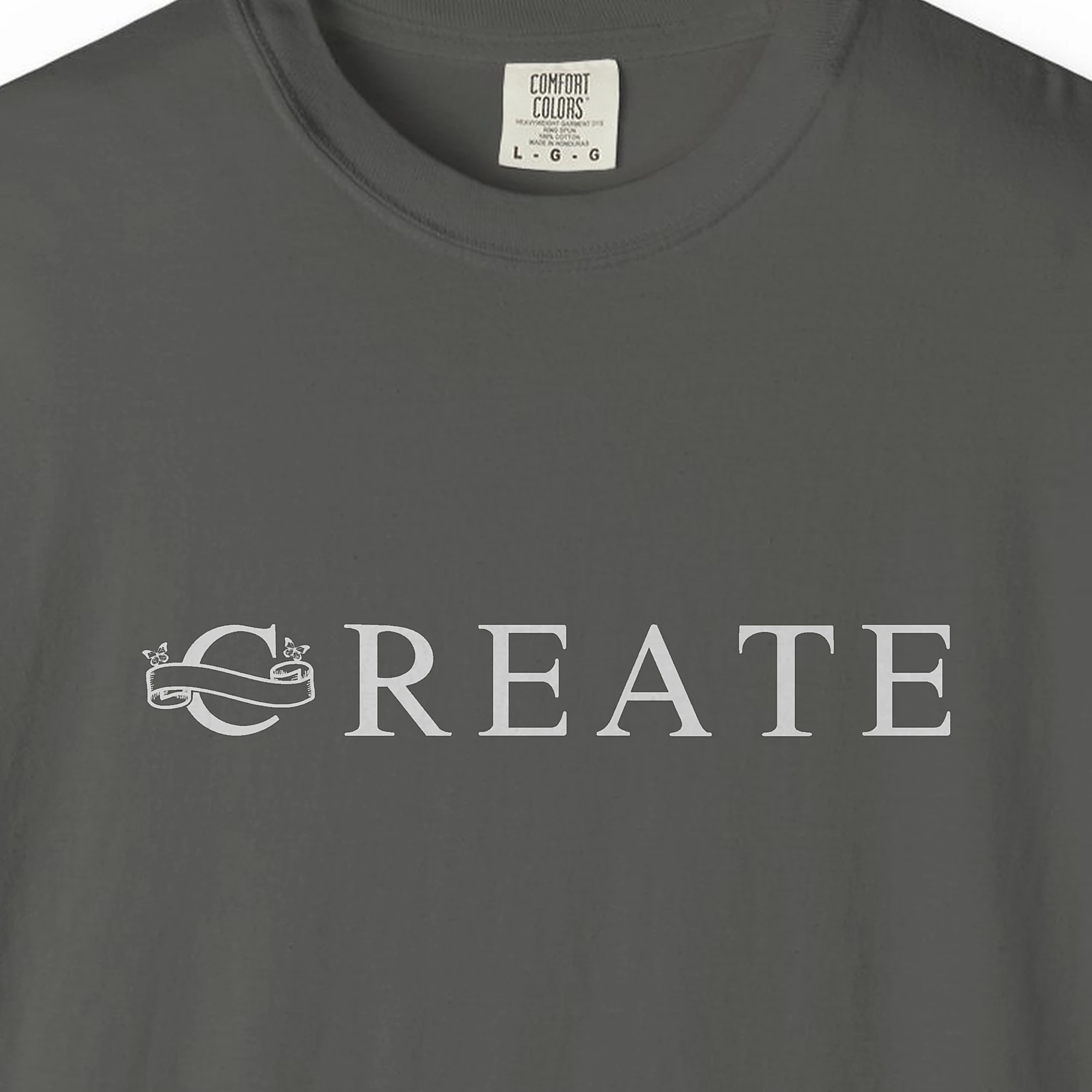 Close-up of the Create print on a Pepper Comfort Colors 1717 tee