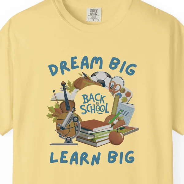Close-up of the Dream Big Learn Big print on a Butter Comfort Colors 1717 tee