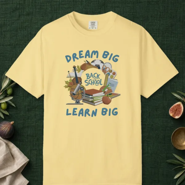 Dream Big Learn Big design on a Butter Comfort Colors 1717 tee, laid flat