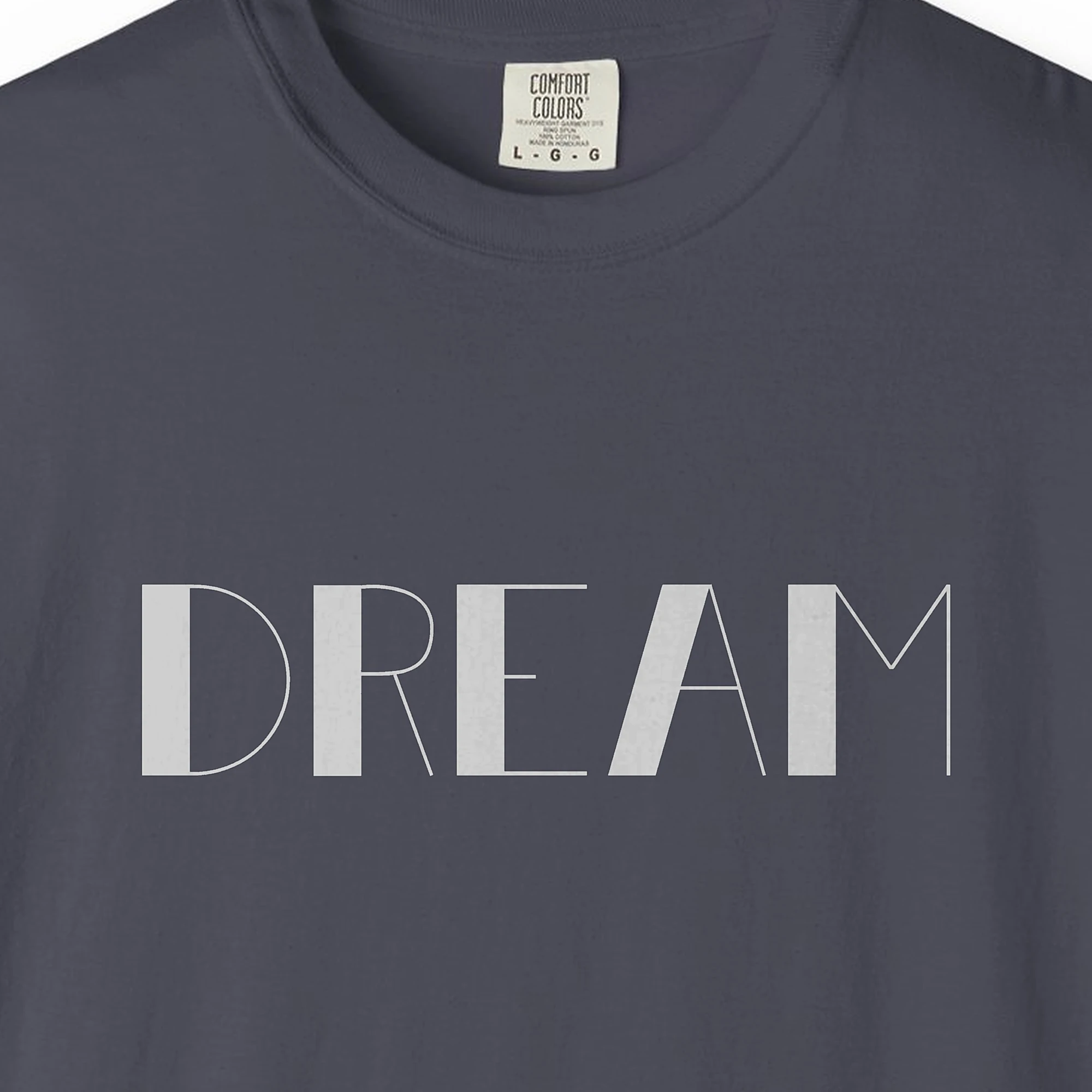 Close-up of the Dream print on a Navy Comfort Colors 1717 tee