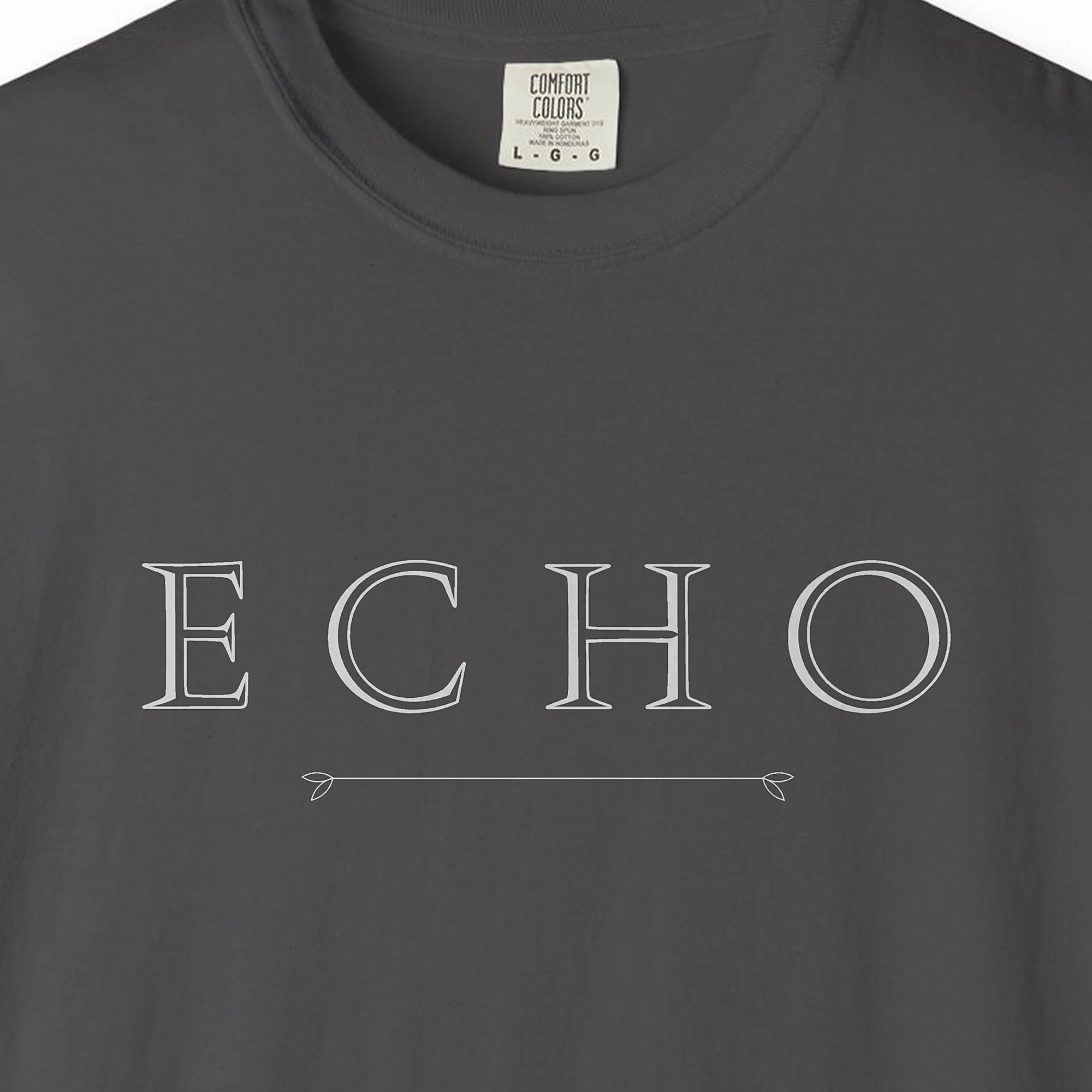 echo-arrow-line-tee-graphite-chest Close-up of the Echo Arrow Line print on a Graphite Comfort Colors 1717 tee