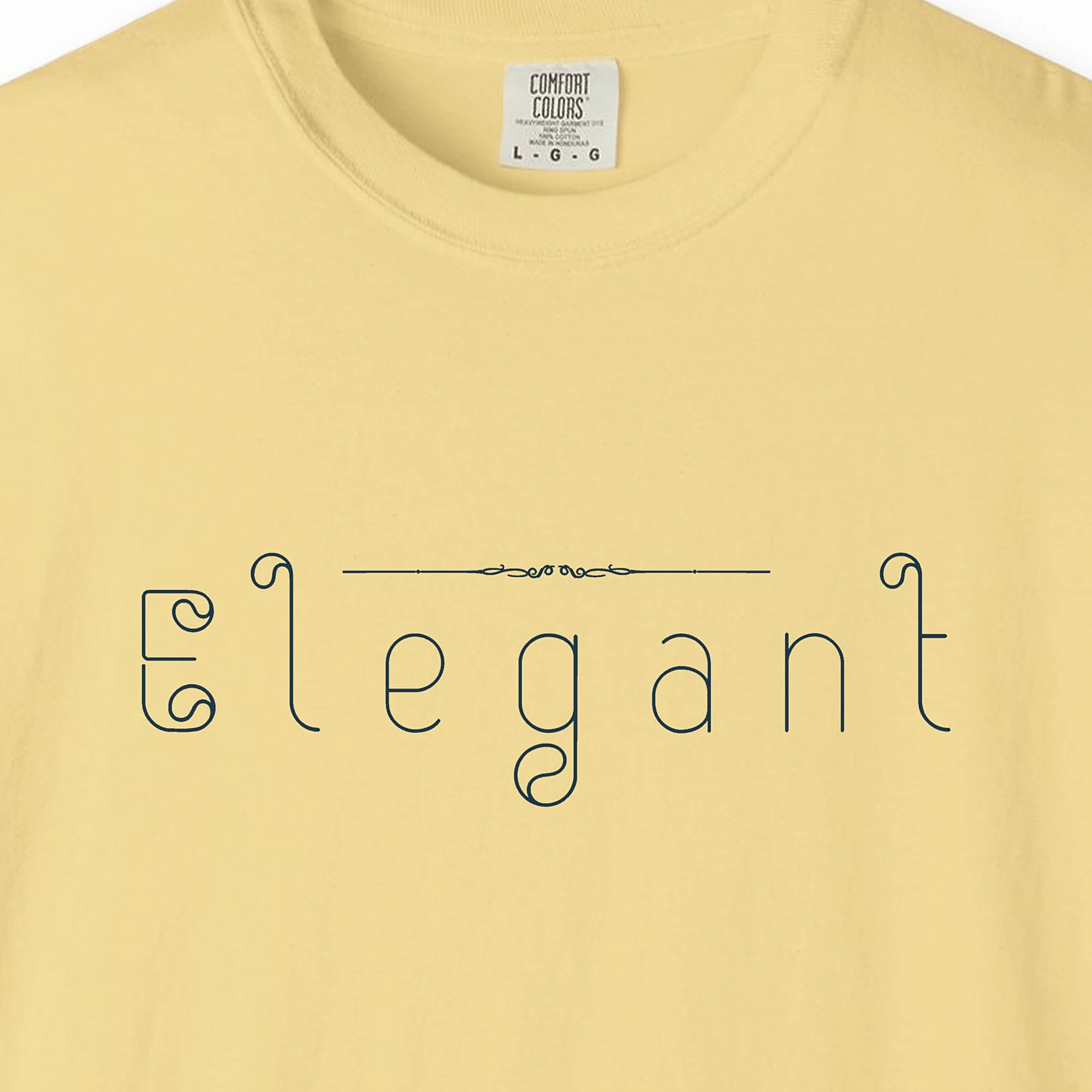 Close-up of the Elegant Outline print on a Butter Comfort Colors 1717 tee
