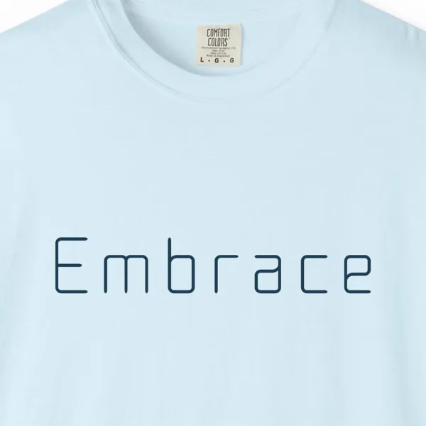embrace-rounded-tee-chambray-chest Close-up of the Embrace Rounded print on a Chambray Comfort Colors 1717 tee
