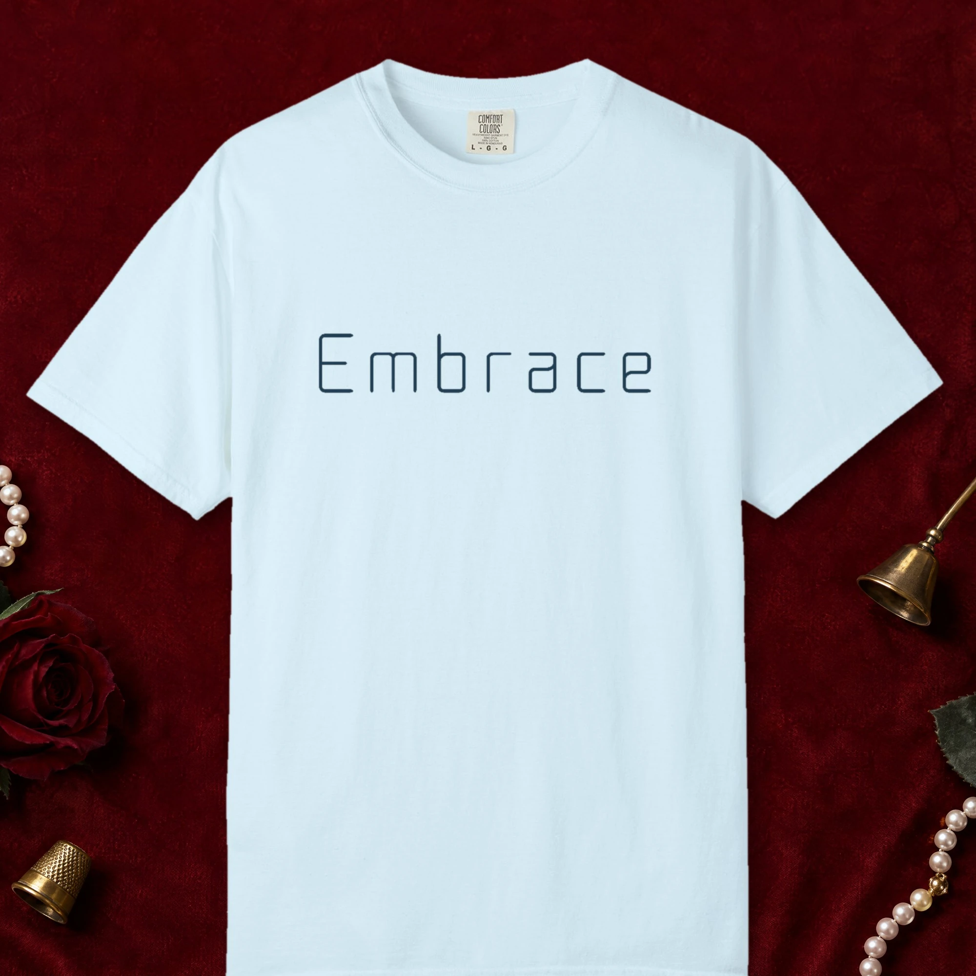 Embrace Rounded design on a Chambray Comfort Colors 1717 tee, laid flat
