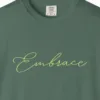 Close-up of the Embrace print on a Blue Spruce Comfort Colors 1717 tee