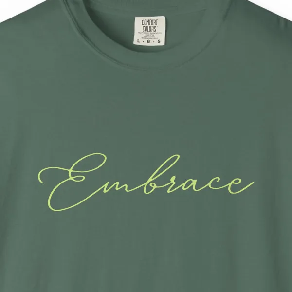 Close-up of the Embrace print on a Blue Spruce Comfort Colors 1717 tee