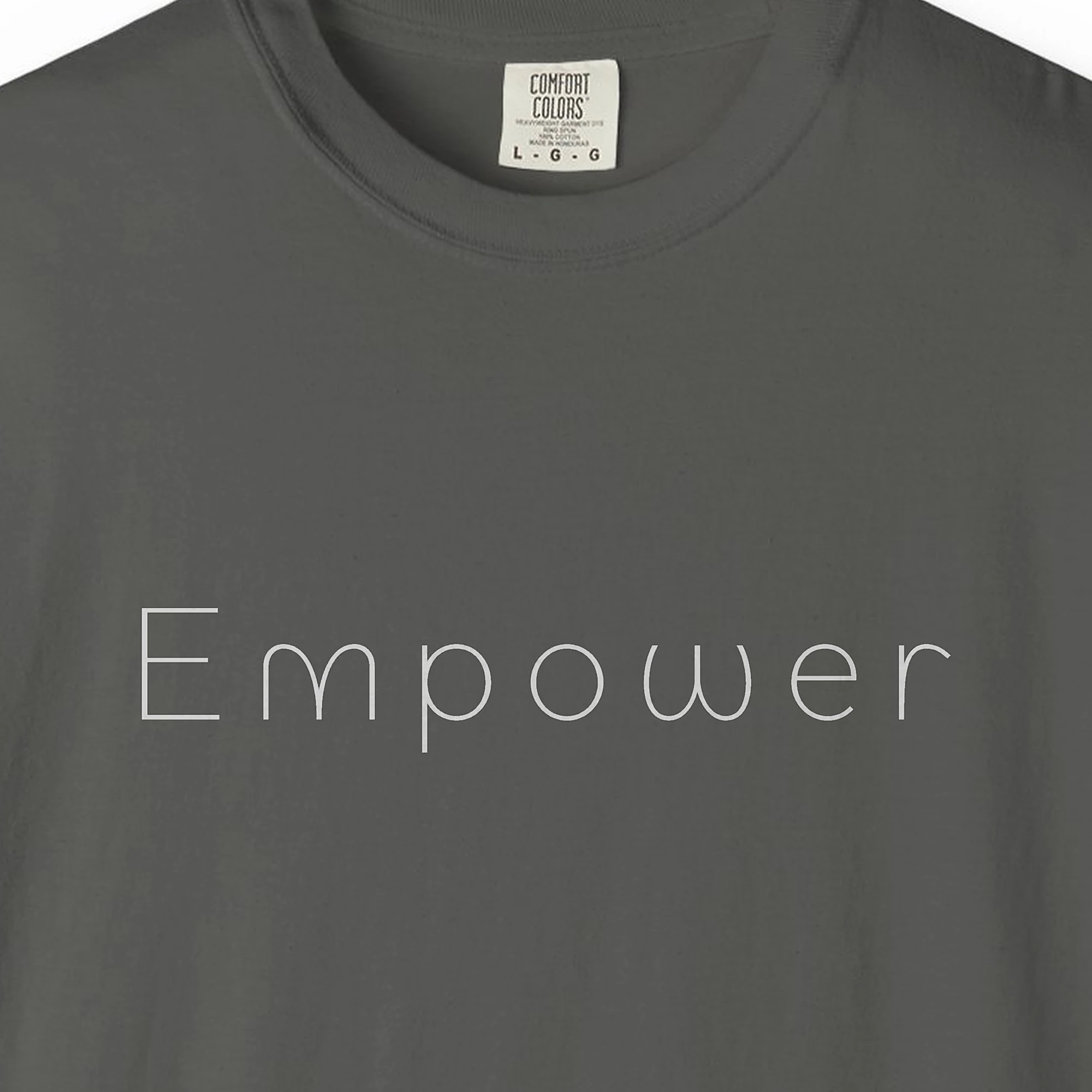 Close-up of the Empower Light Line print on a Pepper Comfort Colors 1717 tee