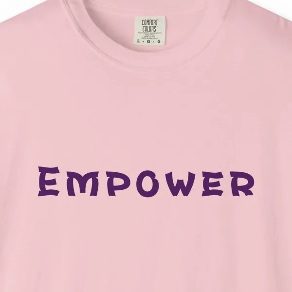 Close-up of the Empower print on a Blossom Comfort Colors 1717 tee
