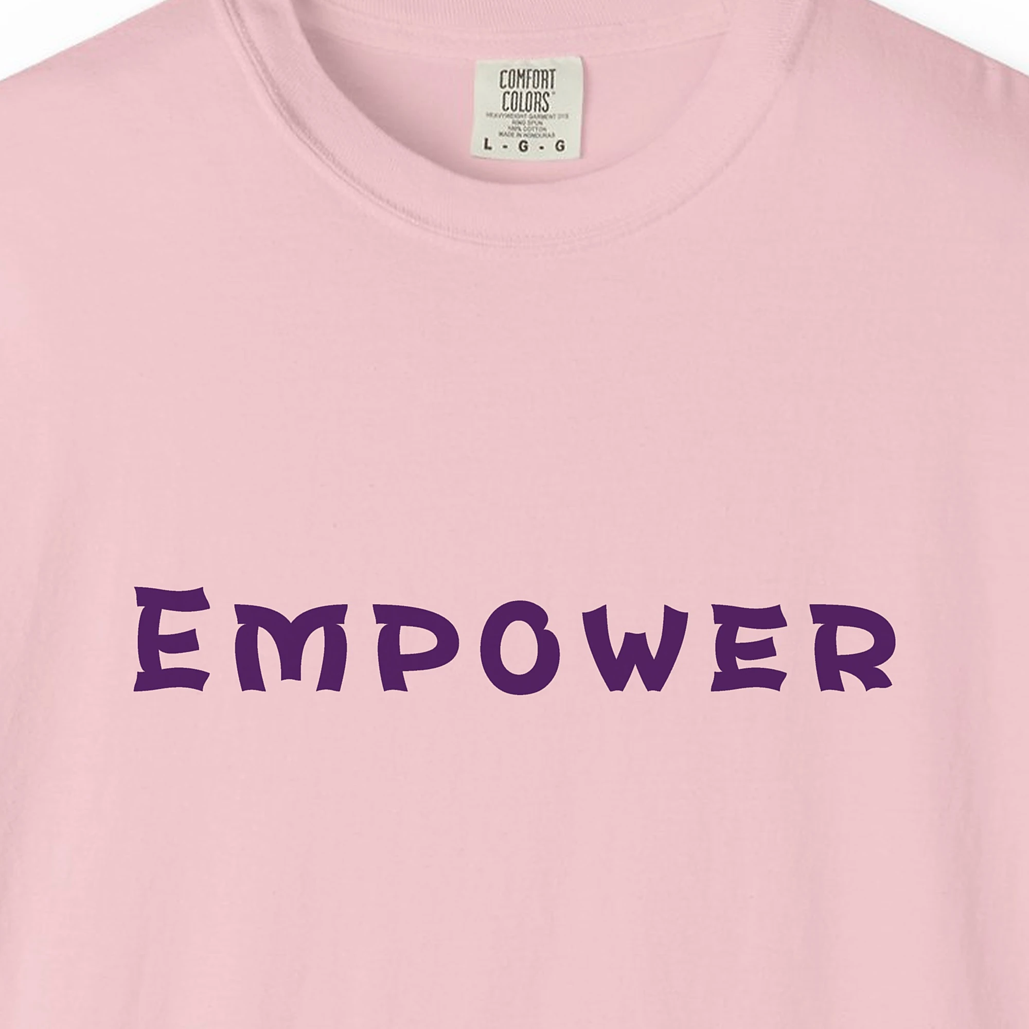 Close-up of the Empower print on a Blossom Comfort Colors 1717 tee