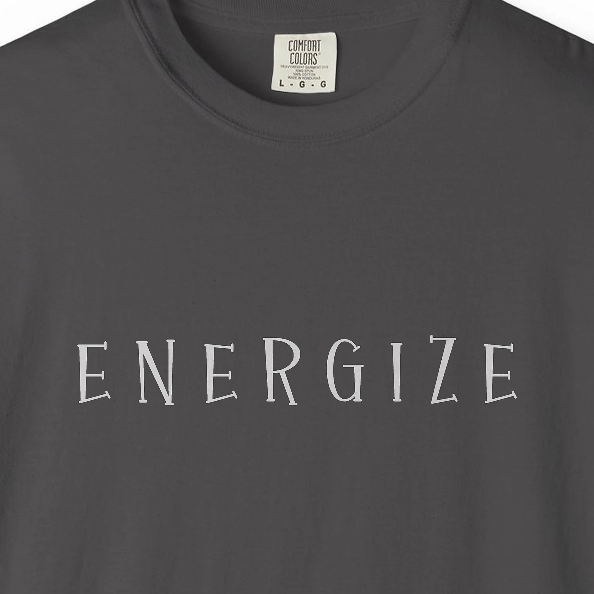 Close-up of the Energize Flared Capitals print on a Graphite Comfort Colors 1717 tee