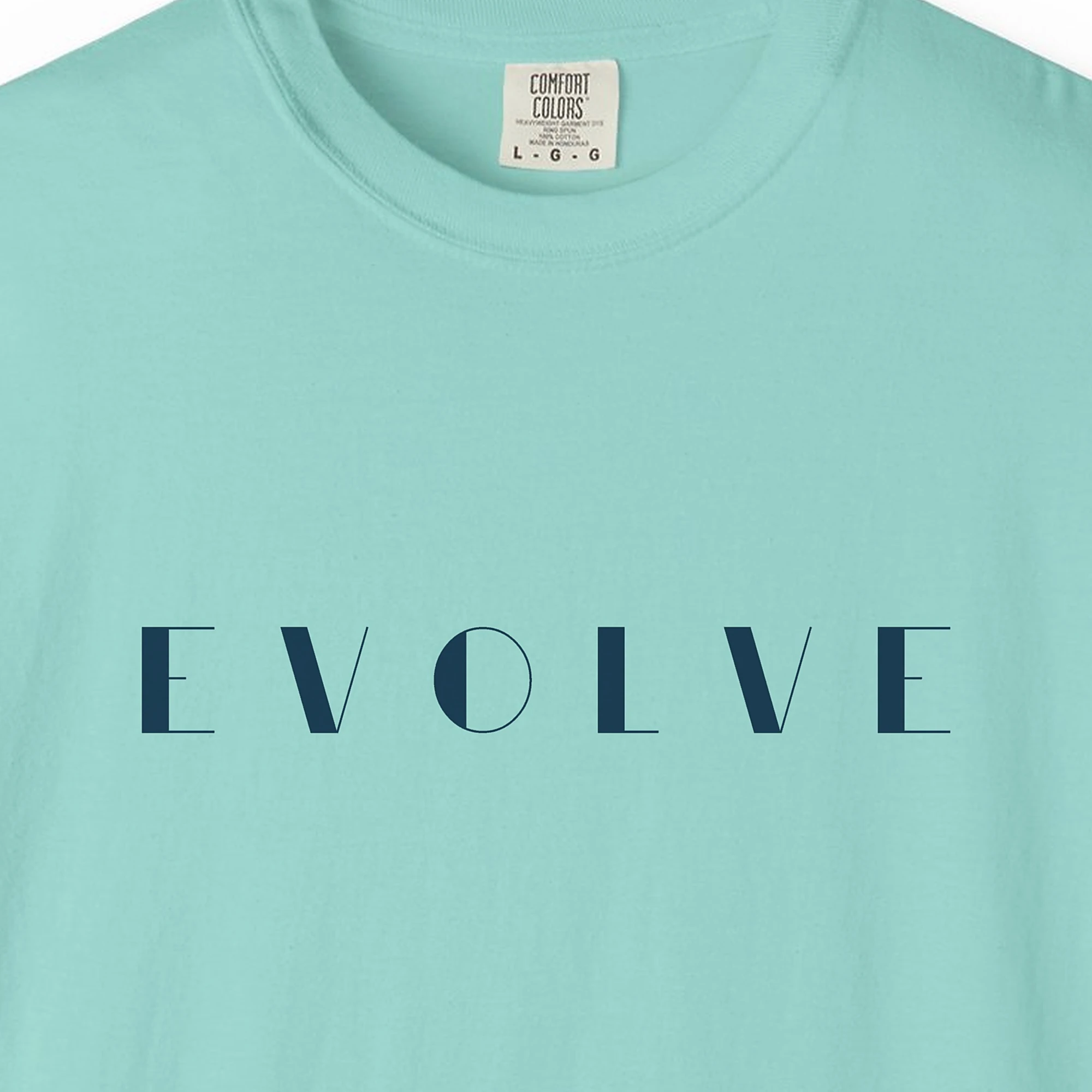 Close-up of the Evolve Art Deco print on a Chalky Mint Comfort Colors 1717 tee