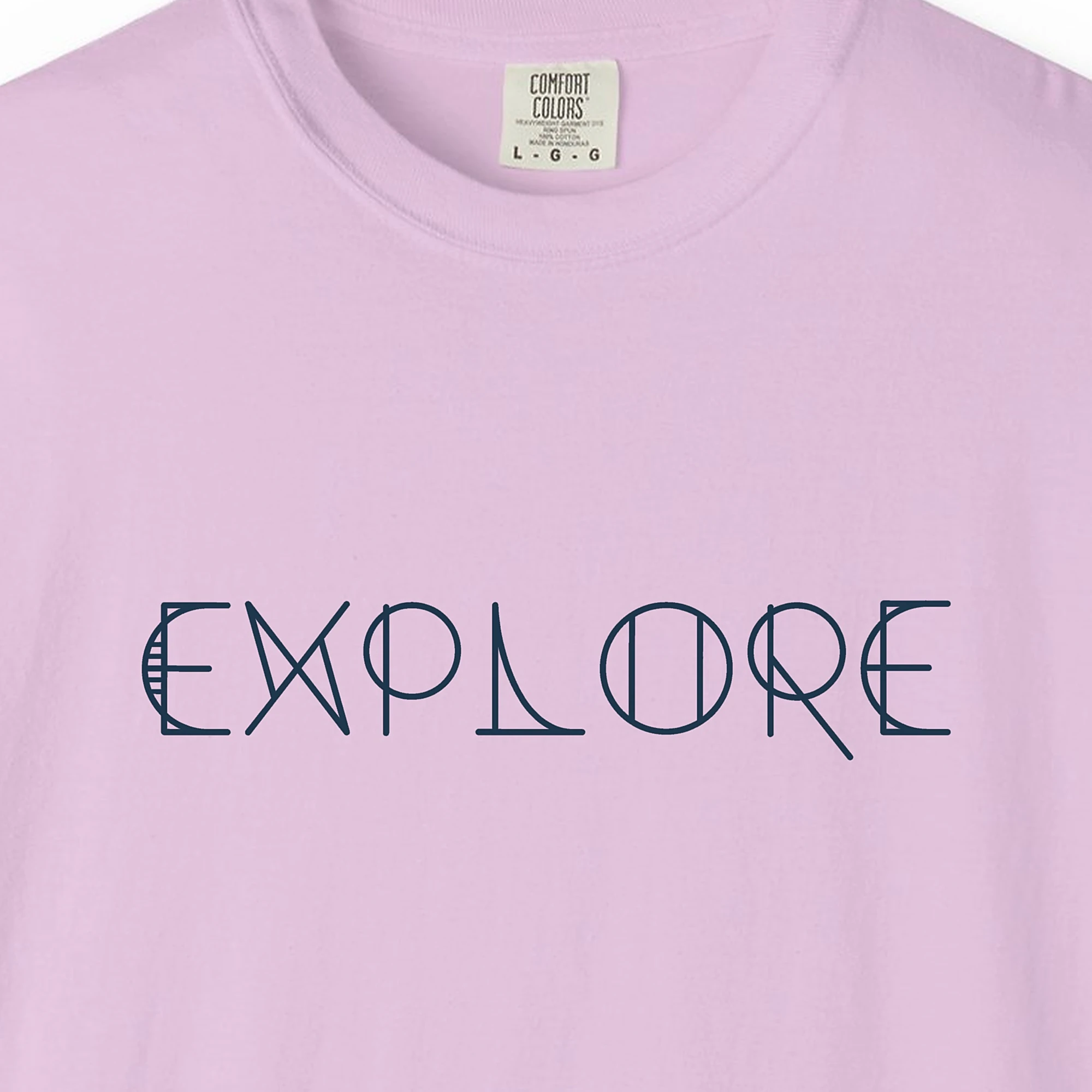 Close-up of the Explore print on a Orchid Comfort Colors 1717 tee