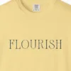 Close-up of the Flourish Tall Serif print on a Butter Comfort Colors 1717 tee