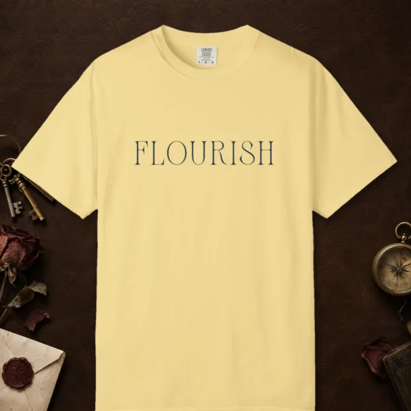Flourish Tall Serif design on a Butter Comfort Colors 1717 tee, laid flat