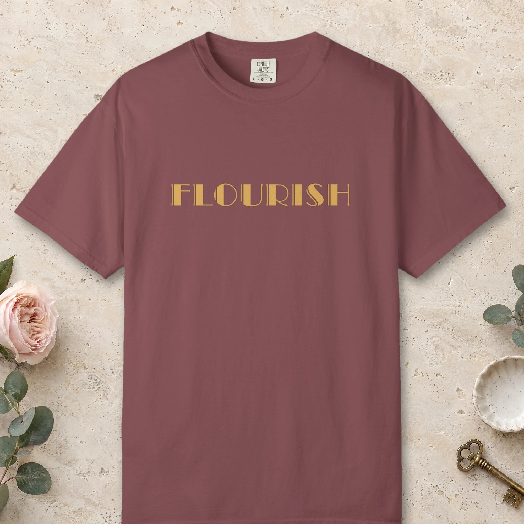 Flourish design on a Brick Comfort Colors 1717 tee, laid flat