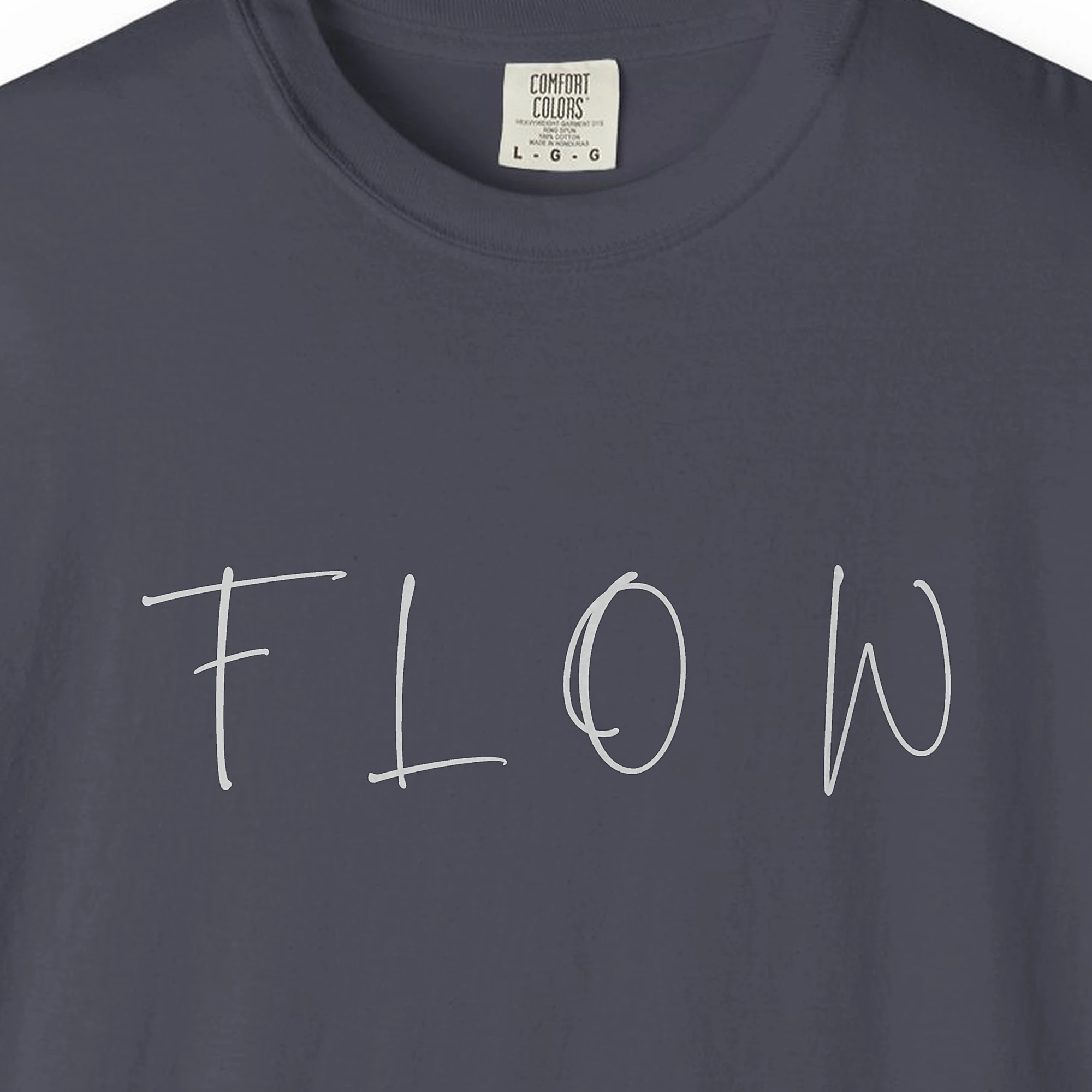 Close-up of the Flow Brush Capitals print on a Navy Comfort Colors 1717 tee
